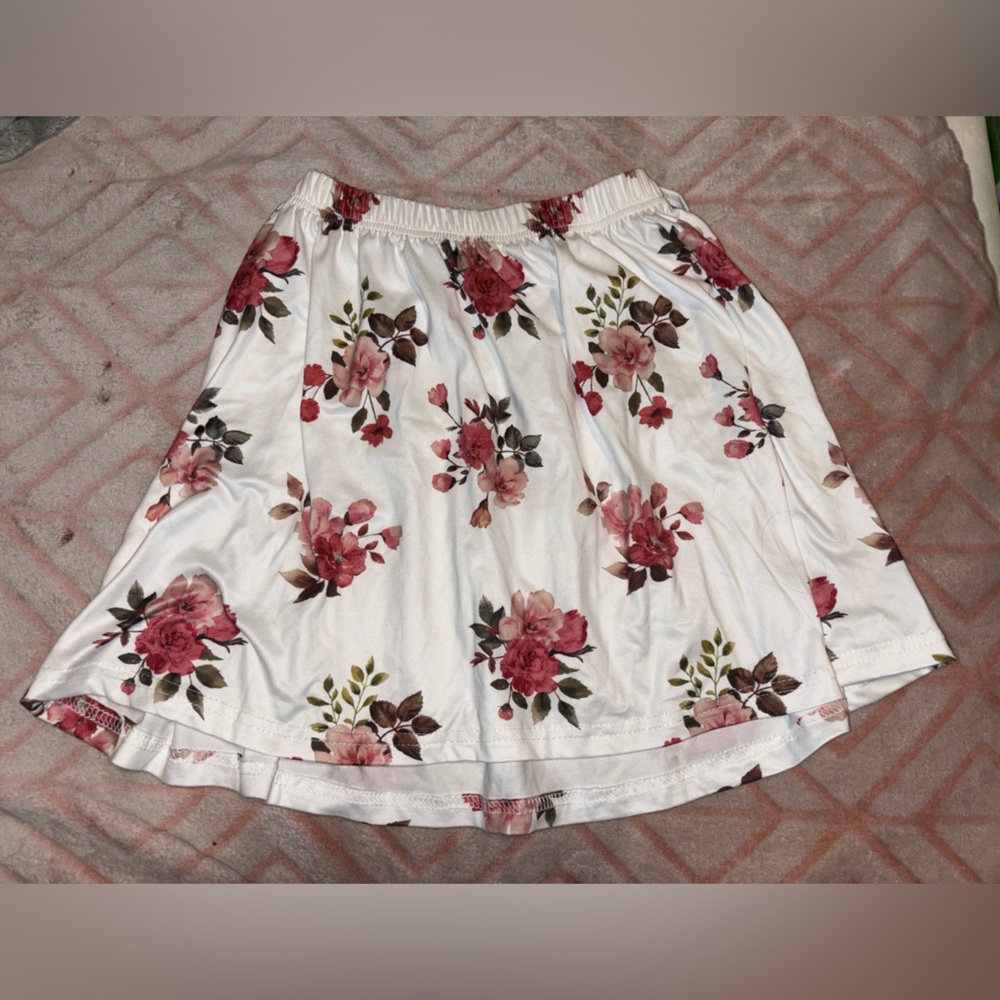 A skirt with White background with pink flowers.